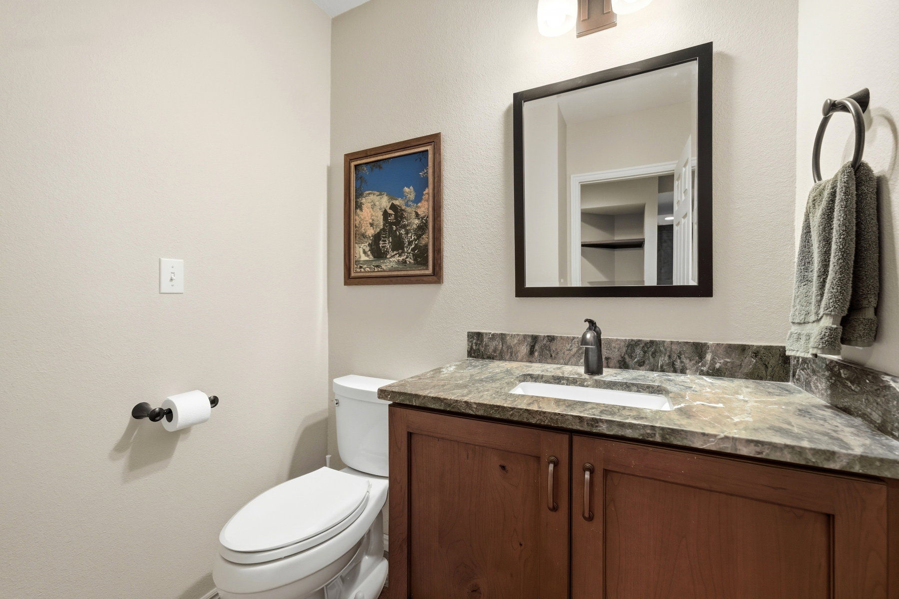 Half bath featuring vanity and a textured wall