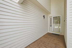 Doorway to property featuring a wooden deck