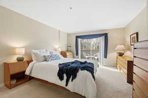 Bedroom featuring light colored carpet