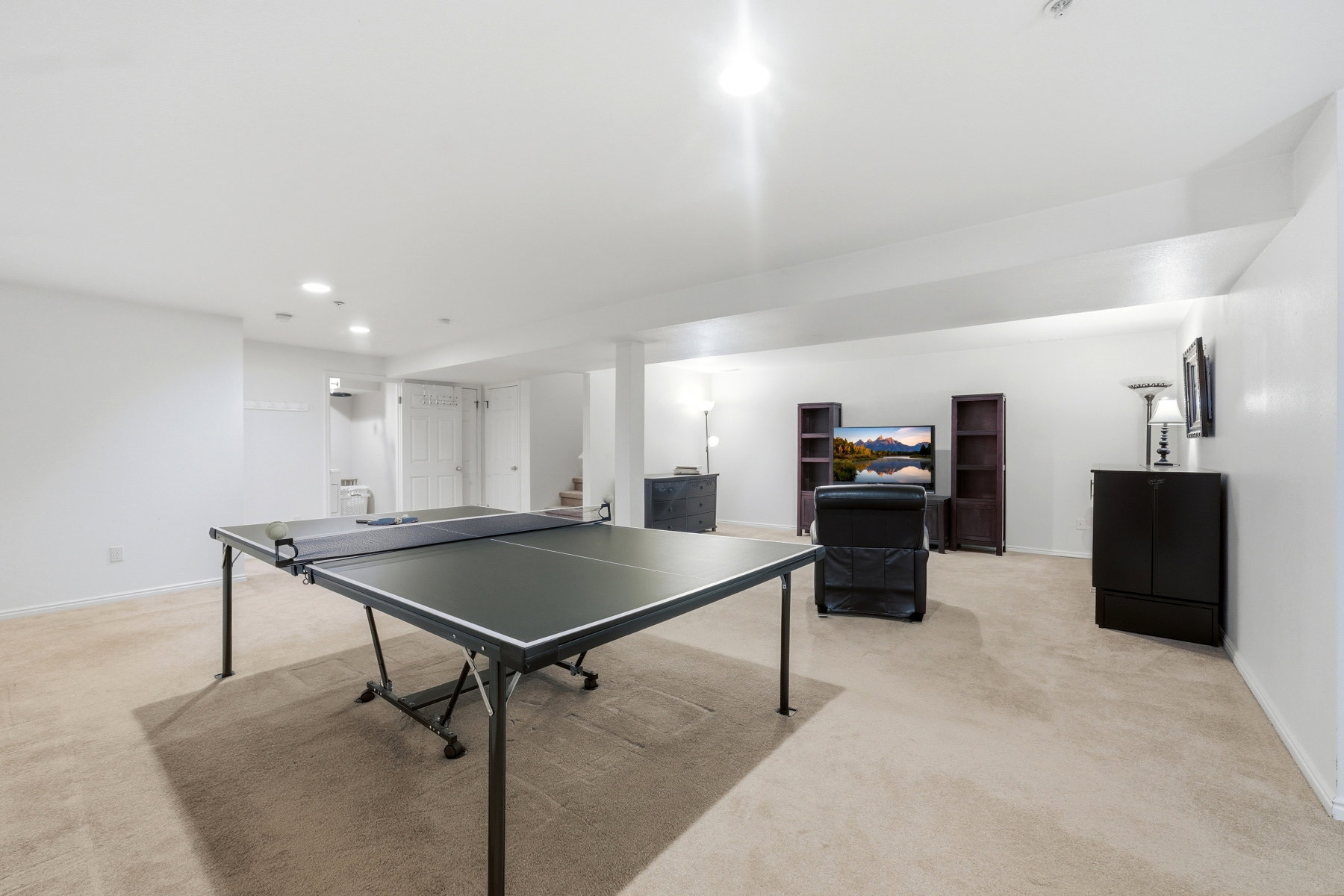 Game room with light colored carpet and recessed lighting