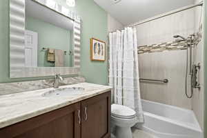 Full bath with vanity and shower / bath combo with shower curtain