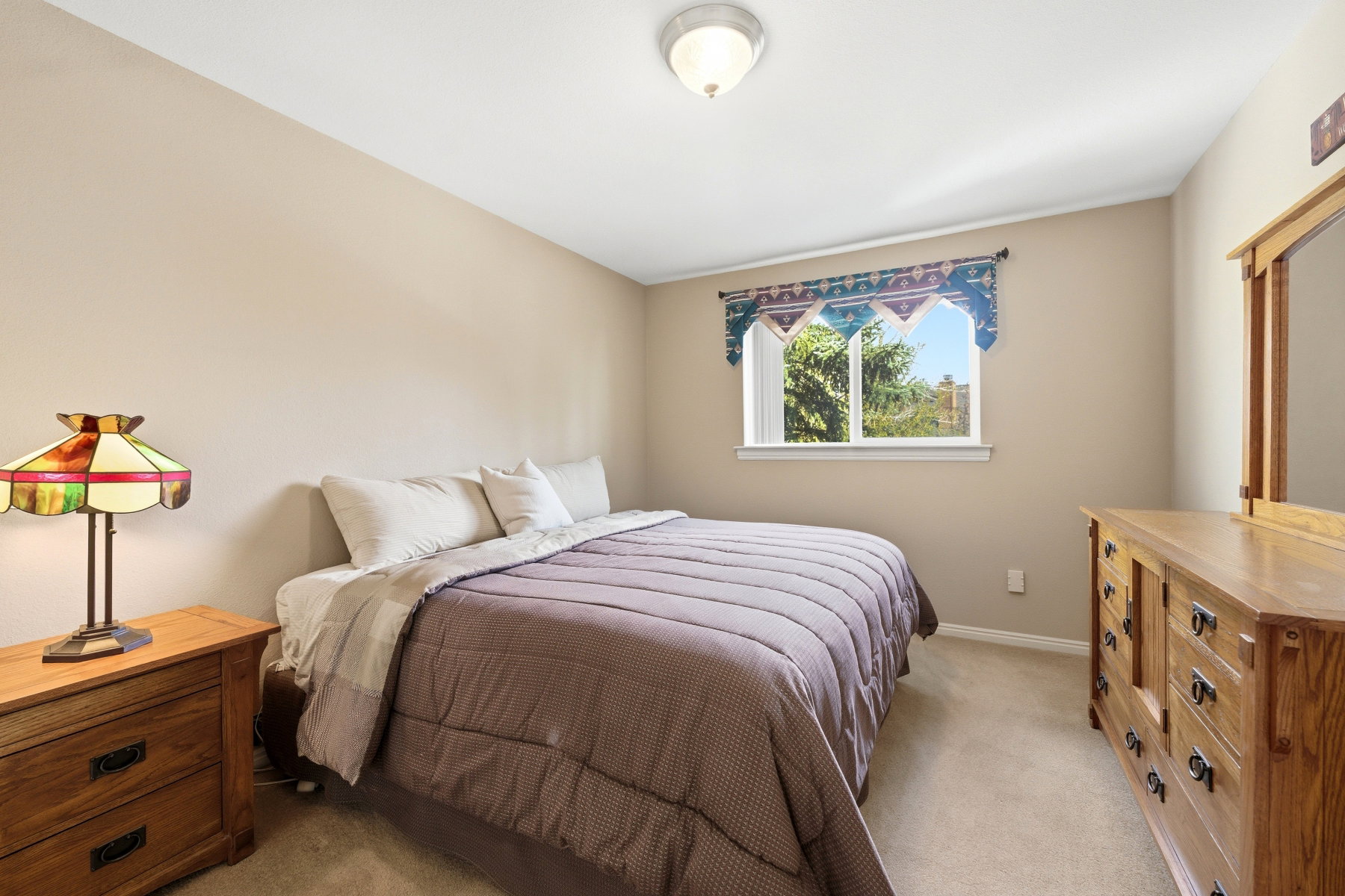 Bedroom featuring light carpet and baseboards