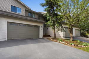 View of front of property featuring asphalt driveway