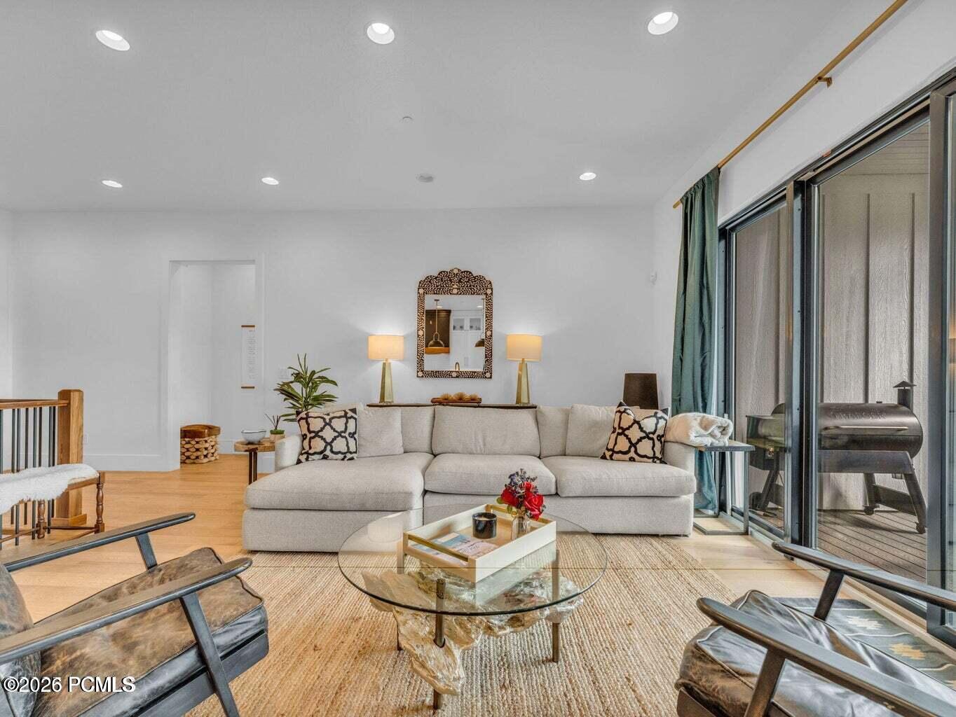 Living area featuring light wood-style floors and recessed lighting