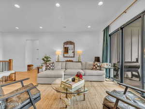 Living area featuring light wood-style floors and recessed lighting