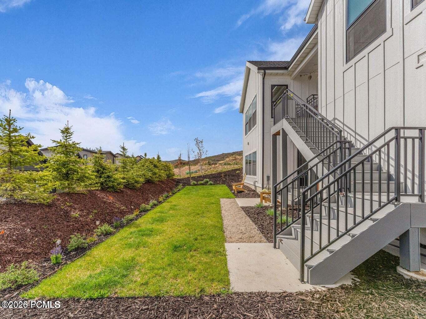 View of grassy yard with stairway