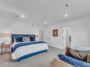 Bedroom featuring light carpet and recessed lighting