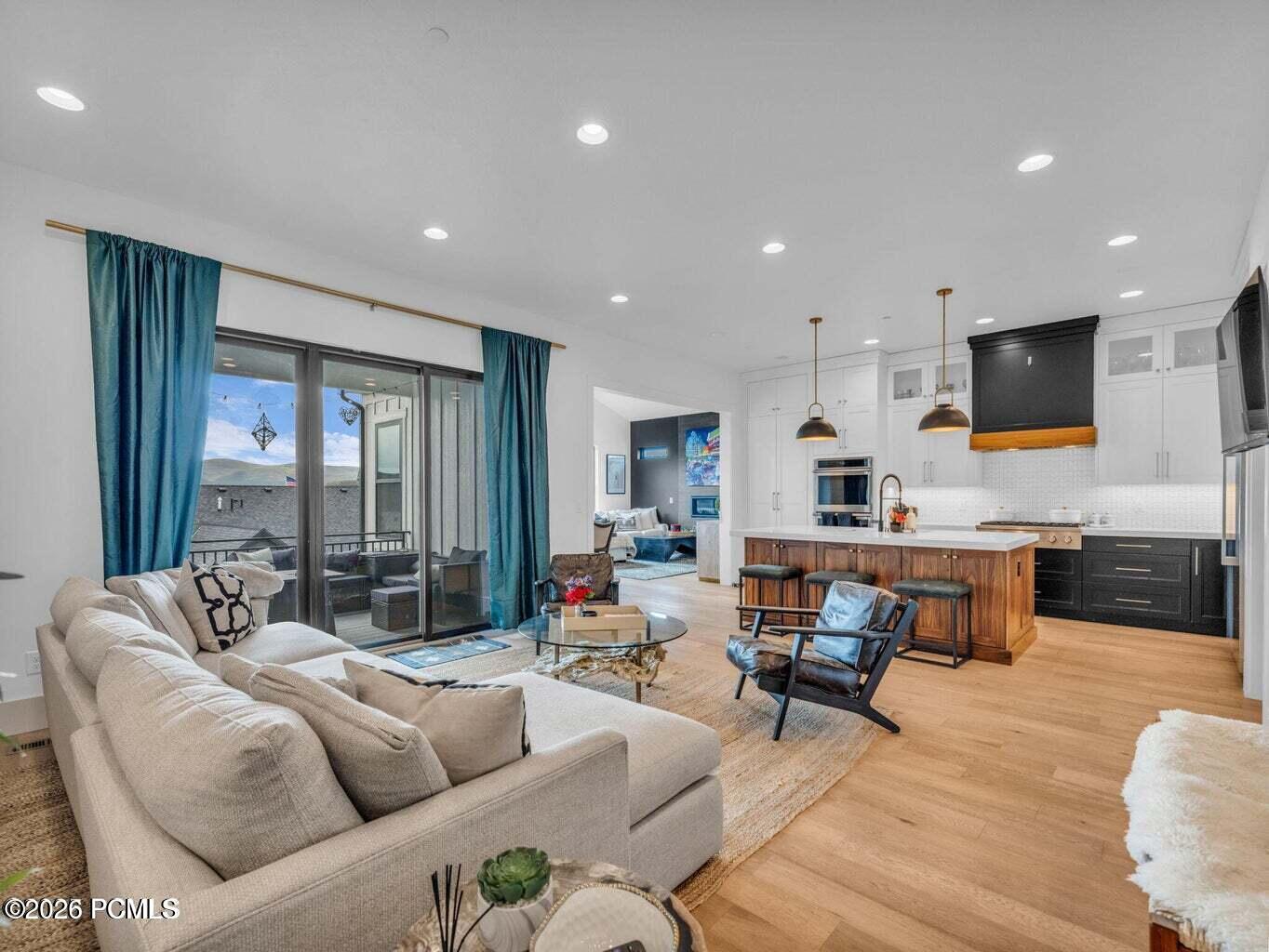 Living room featuring light wood-style flooring and recessed lighting
