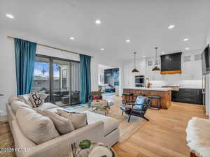 Living room featuring light wood-style flooring and recessed lighting