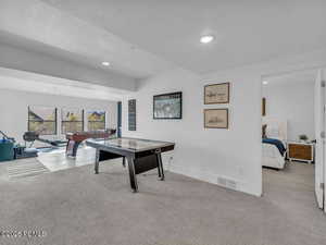 Game room featuring light carpet, a textured ceiling, and recessed lighting