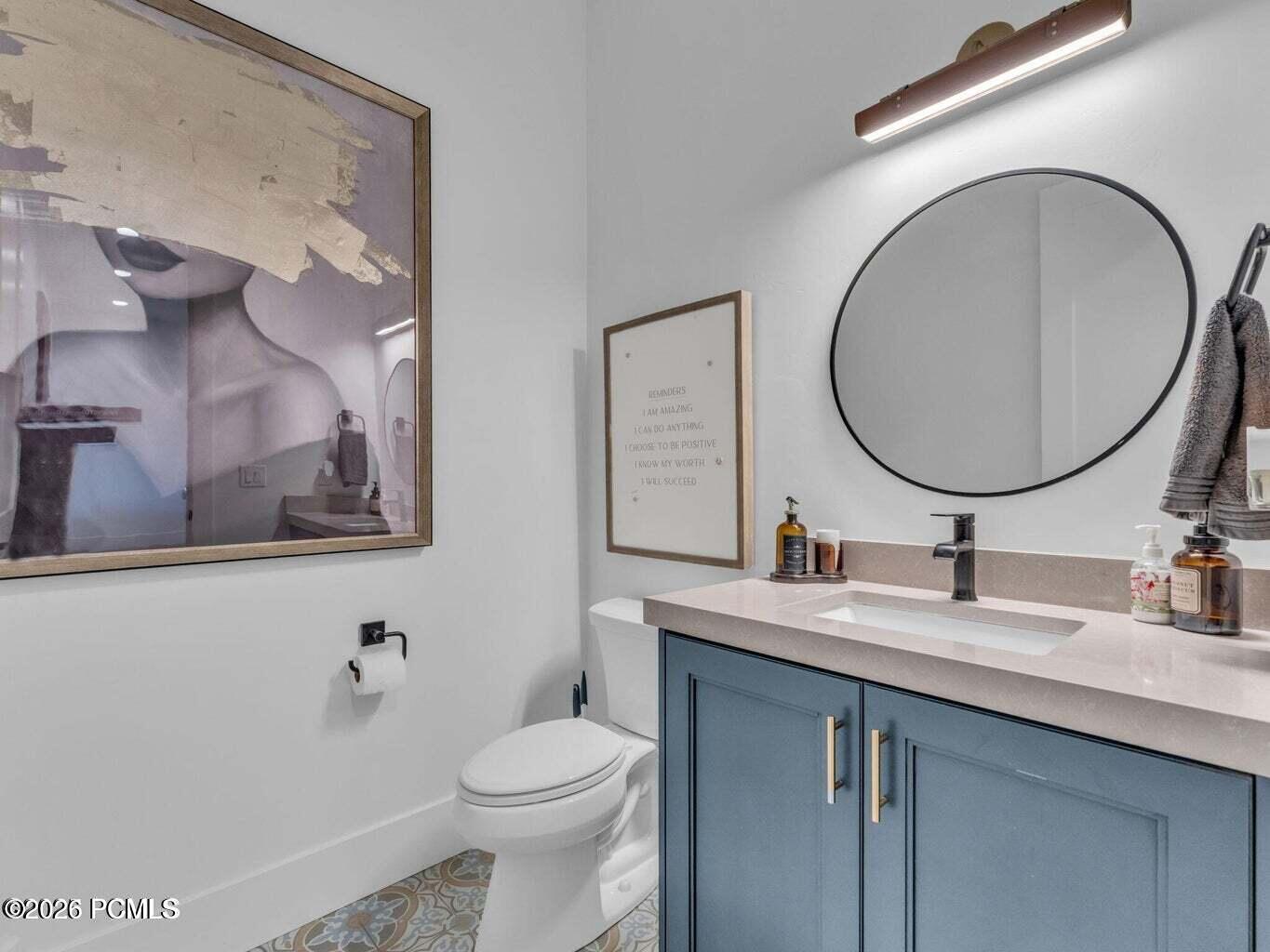 Half bath featuring vanity and toilet
