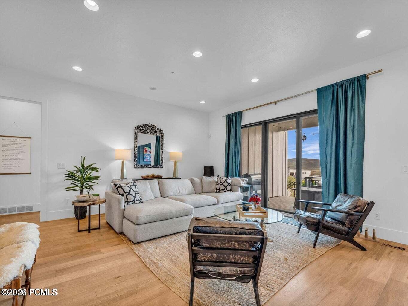 Living area featuring light wood-type flooring and recessed lighting