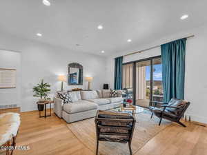 Living area featuring light wood-type flooring and recessed lighting