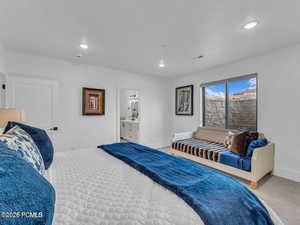 Bedroom featuring carpet flooring, recessed lighting, and ensuite bathroom
