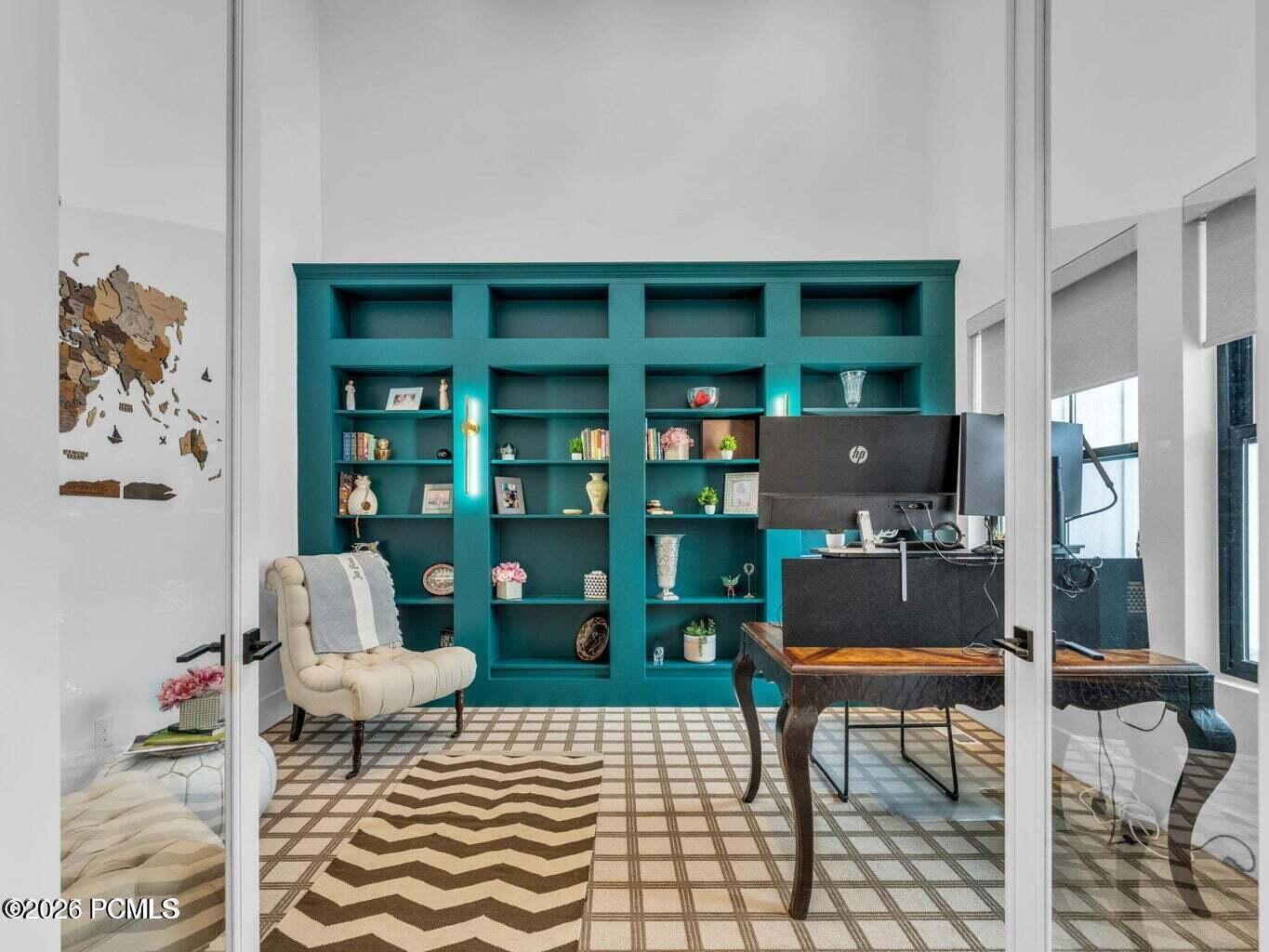 Home office with a high ceiling and built in features