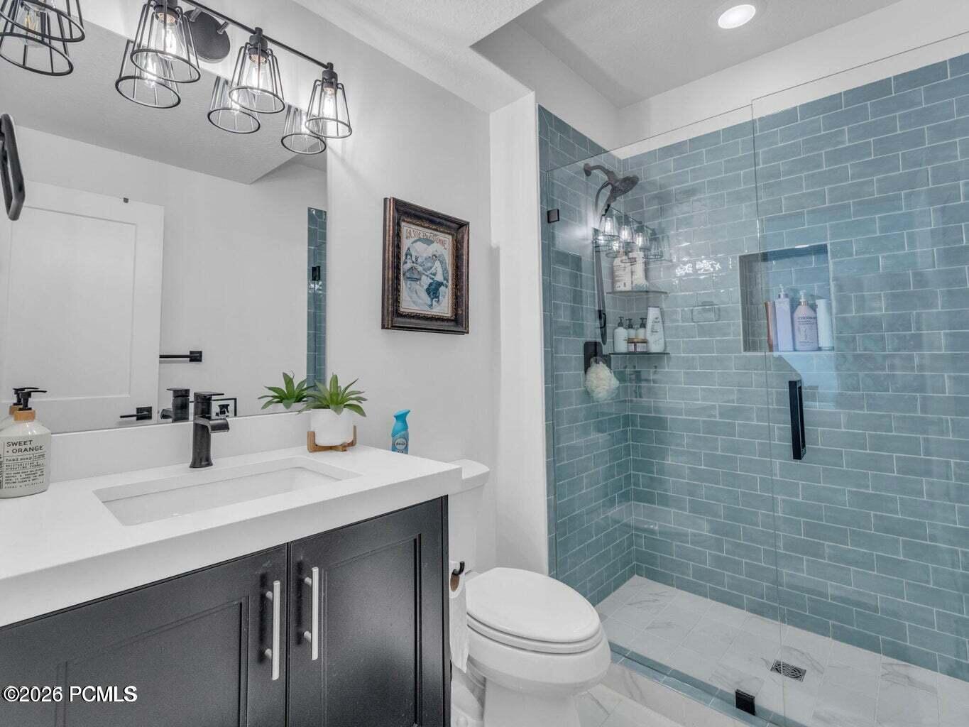 Full bath with vanity and a stall shower