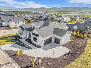 Aerial perspective of suburban area featuring a mountain backdrop