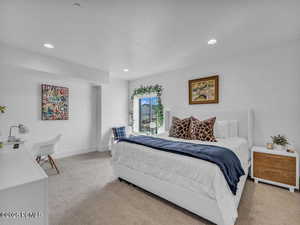 Bedroom with light colored carpet, a textured ceiling, and recessed lighting