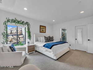 Carpeted bedroom featuring recessed lighting and ensuite bathroom