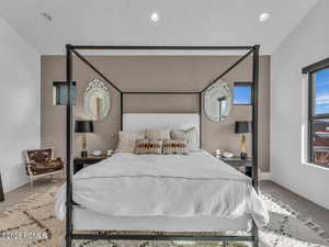 Bedroom with carpet floors, recessed lighting, and vaulted ceiling