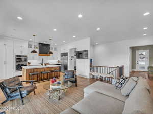 Living area featuring light wood finished floors and recessed lighting
