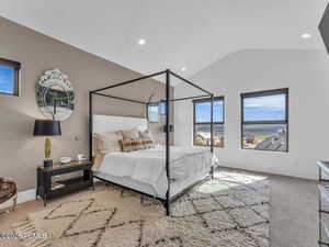 Bedroom featuring lofted ceiling, light colored carpet, and recessed lighting