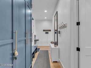 Bathroom featuring light wood-style flooring, recessed lighting, and vanity