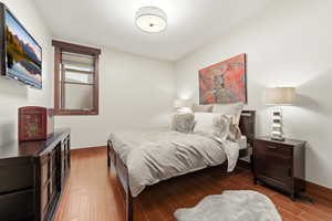 Bedroom with baseboards and wood tiled floors