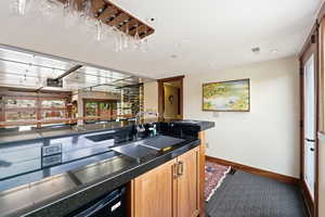 Kitchen featuring dishwasher, light wood finish cabinetry, and recessed lighting