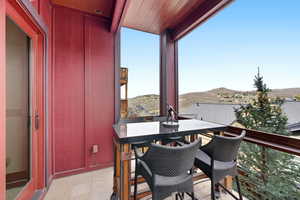 Balcony with a mountain view and outdoor dining space