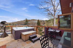 View of patio with a hot tub