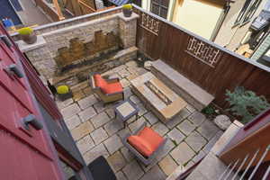View of patio featuring grilling area and an outdoor stone fireplace