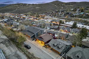 Aerial perspective of suburban area featuring a mountainous background