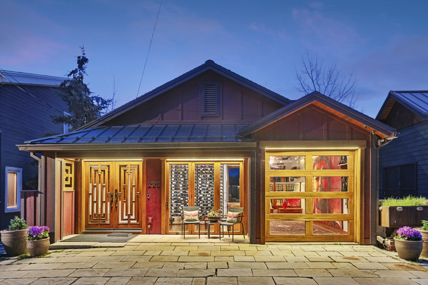 Property entrance with board and batten siding, a standing seam roof, and covered porch