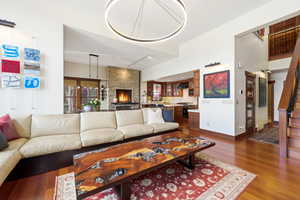 Living area with rail lighting and dark wood-type flooring