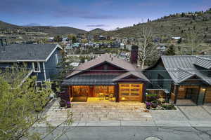 View of front of property featuring driveway, a mountain view, and a residential view