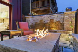 View of patio with an outdoor fire pit