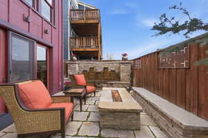 Patio / terrace with a fire pit, a patio area, and a fenced backyard