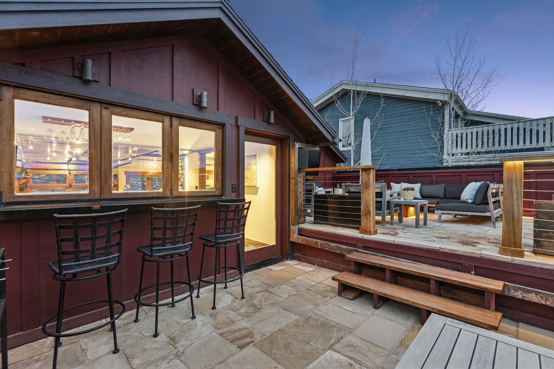 Wooden deck with an outdoor lounge area with bar