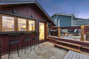 Wooden deck with an outdoor lounge area with bar