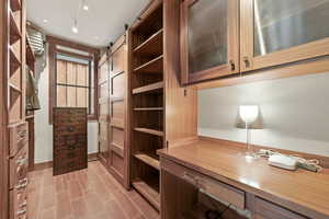 Unfurnished office with a barn door and wood finish floors