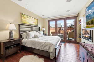 Bedroom featuring access to outside and wood tiled floors