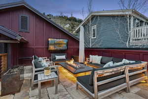 View of patio with an outdoor living space with a fire pit