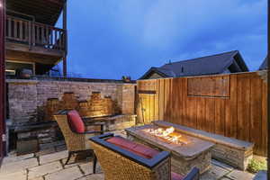 Fenced backyard with a patio area and a fire pit
