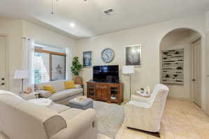 Living area with light tile patterned floors, recessed lighting, and a ceiling fan