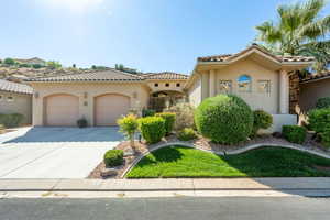 Mediterranean / spanish-style house featuring stucco siding, concrete driveway, an attached garage, and a tile roof