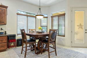 Dining area with light tile patterned flooring