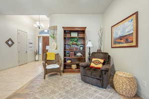 Sitting room featuring wood finished floors and hanging lights