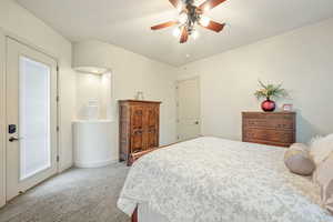 Bedroom with light carpet and a ceiling fan
