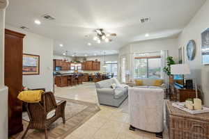 Living room with ceiling fan, light tile patterned floors, and recessed lighting